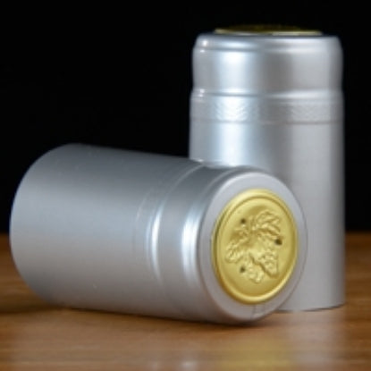 Silver and gold wine capsule